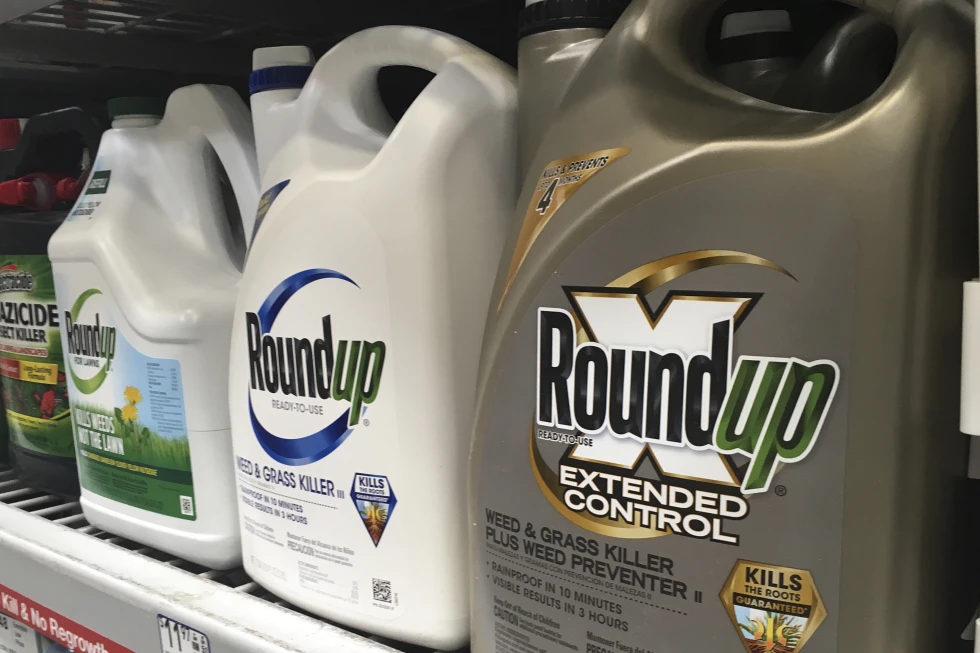 Roundup weed killer bottles on store shelf.